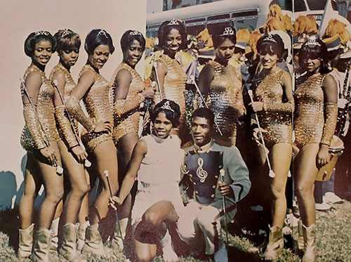 old image of the original Golden Girls team grouped together in a gold coloured uniform taking a group picture together